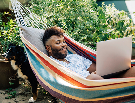 Student in Hammock with Dog